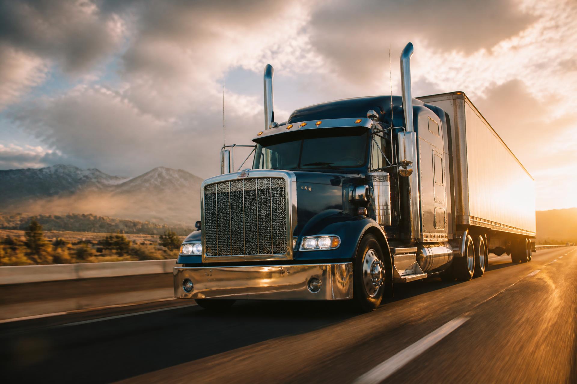 American semi-truck on an interstate highway at golden hour